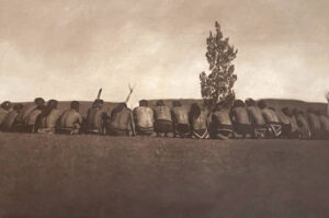 A group of people sitting on top of a wall.