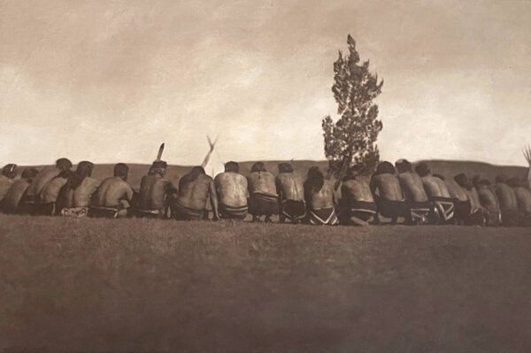 A group of people sitting on top of a wall.