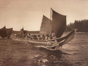 A group of people in small boats on the water.