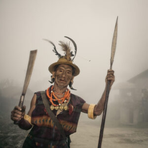 A man holding two spears in his hands.