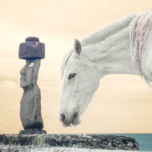 A white horse standing next to a statue.