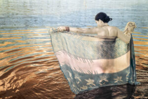 A woman in the water with her arms out