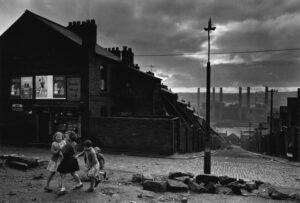 A group of children are walking on the street.