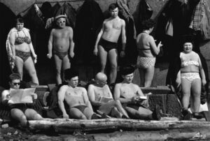 A group of men and women in bathing suits.
