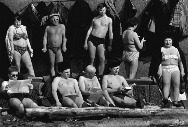 A group of men and women in bathing suits.