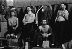 A group of men sitting next to each other.