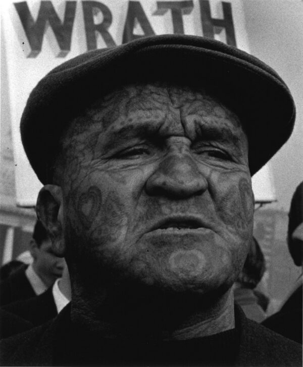 A man with tattoos on his face and head.