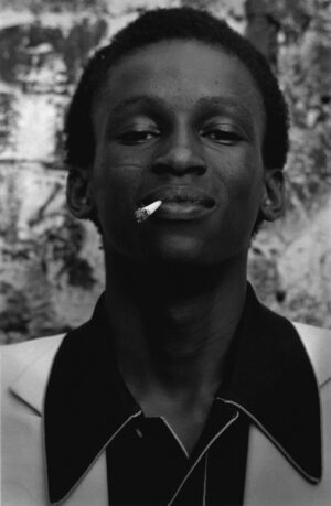 A man with a cigarette in his mouth.