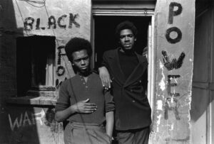 Two men standing in front of a building.