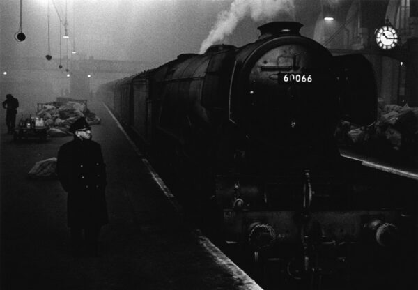 A train is on the tracks at night.