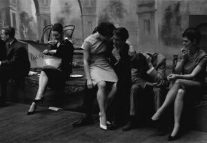 A group of people sitting on a bench.