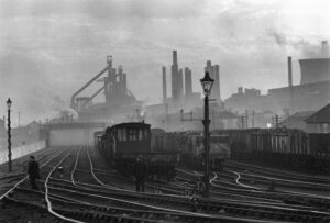 A train yard with many trains on the tracks.