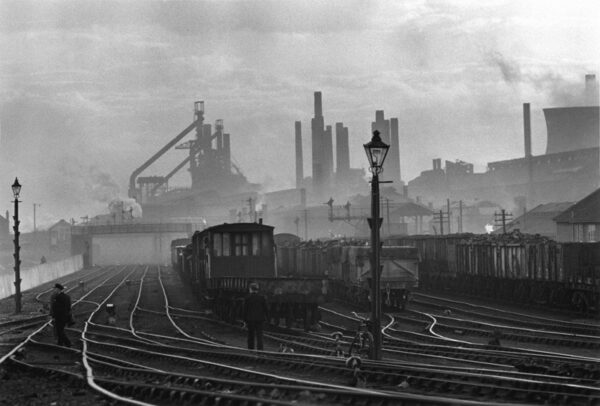 A train yard with many trains on the tracks.