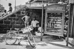 A black and white photo of people standing outside