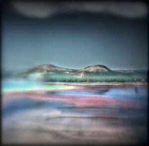 A blurry image of mountains and water