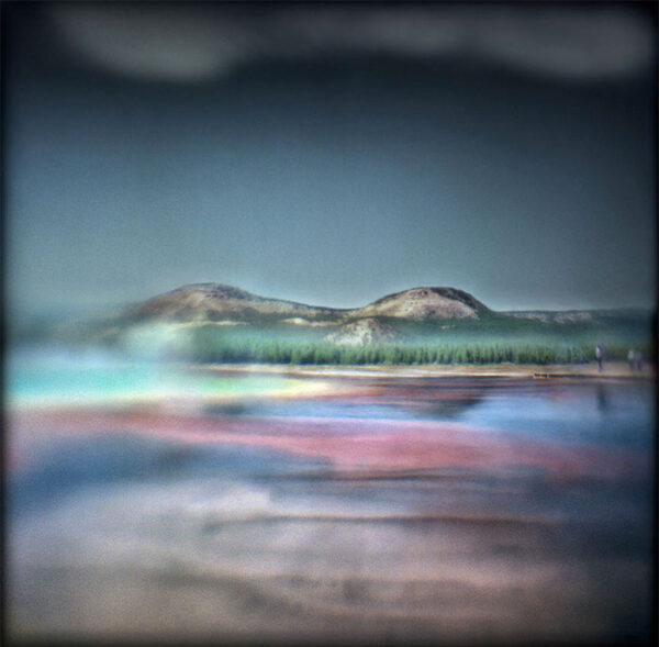 A blurry image of mountains and water