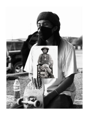 A man holding up a picture of himself.
