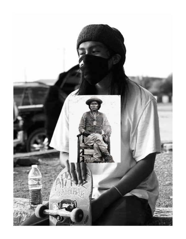 A man holding up a picture of himself.