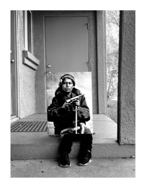 A person sitting on the steps of a house