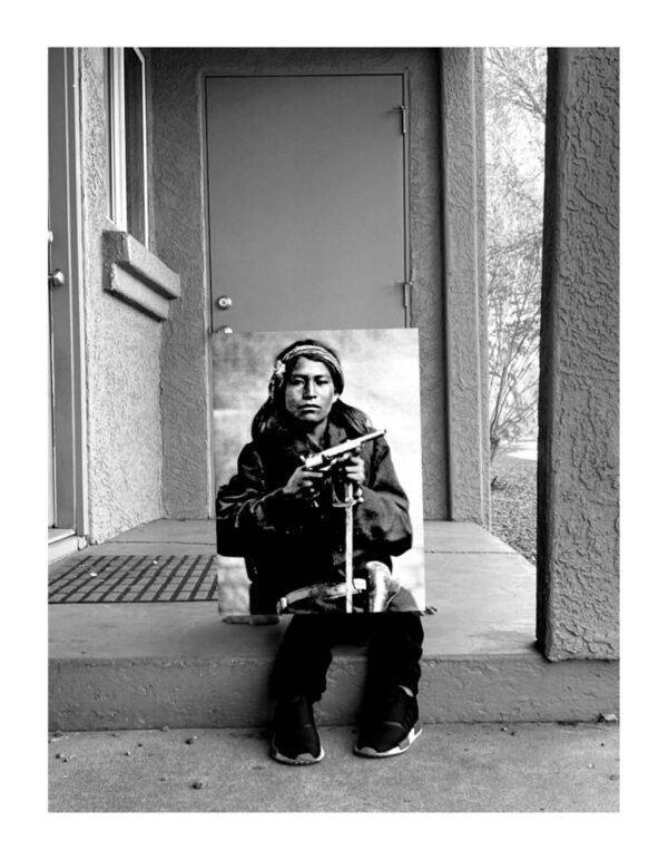 A person sitting on the steps of a house