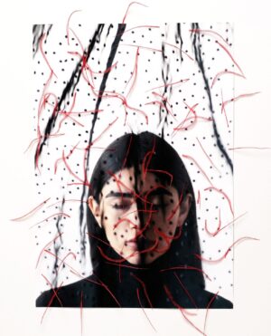 A woman with long black hair and red string.