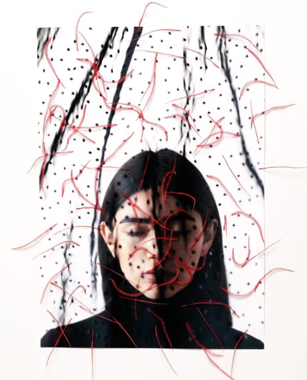 A woman with long black hair and red string.