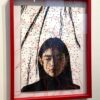 A red frame with a picture of a woman in it