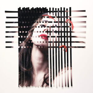A woman with red lipstick is in front of black and white stripes.