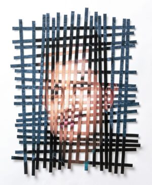 A man 's face is cut out of paper.