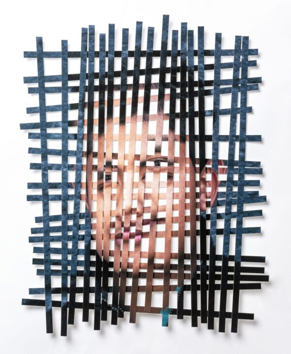 A man 's face is cut out of paper.
