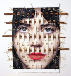 A woman 's face made out of toothpicks and nails.