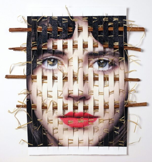 A woman 's face made out of toothpicks and nails.