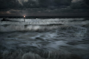 A light post in the middle of the ocean