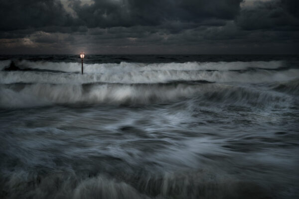 A light post in the middle of the ocean