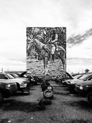 A large painting of a man on horseback in the middle of a parking lot.