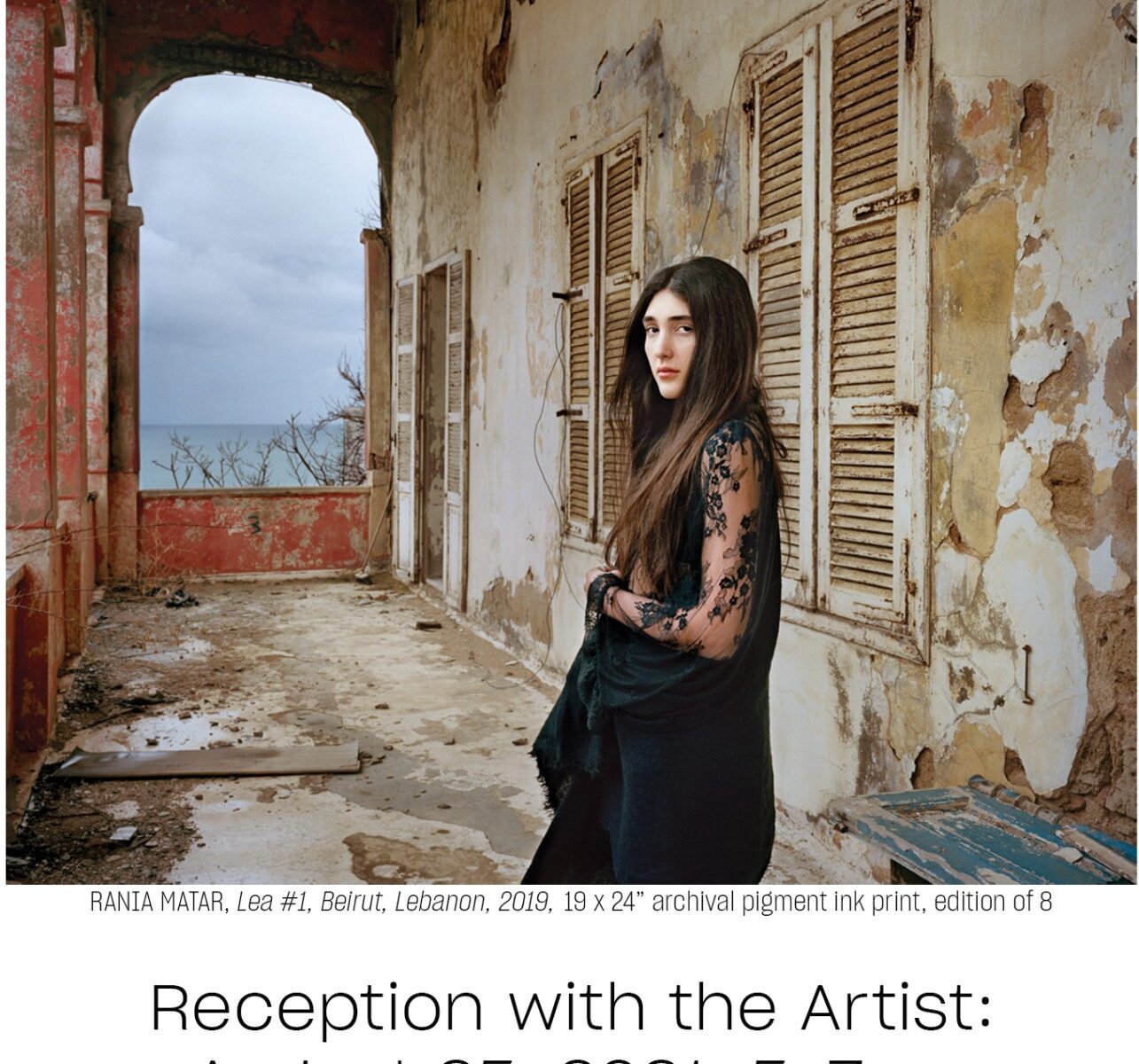 Young woman stands by weathered, open window.