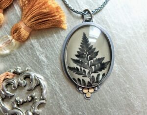 A necklace with a picture of a tree on it.
