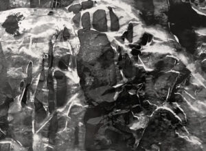 A black and white photo of a hand print.