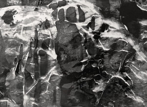A black and white photo of a hand print.