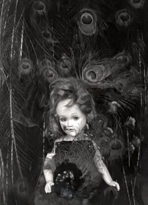 A black and white photo of a child holding an object.
