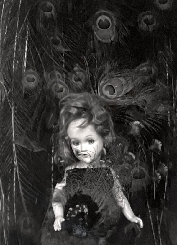 A black and white photo of a child holding an object.