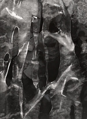 A black and white photo of hands in water.