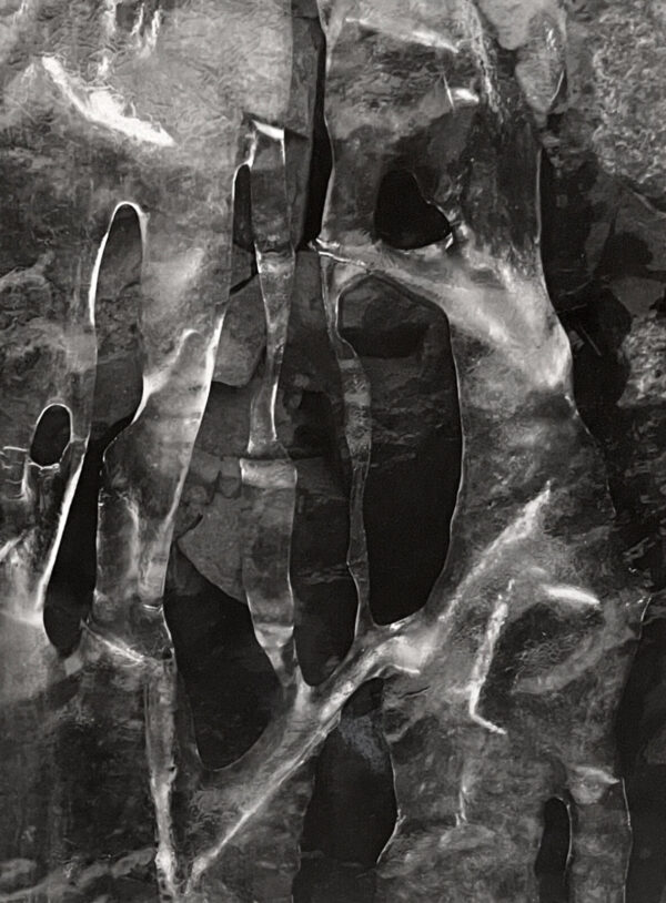 A black and white photo of hands in water.