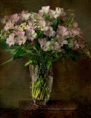 A vase filled with pink flowers on top of a table.