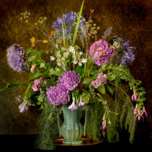 A vase filled with purple flowers on top of a table.