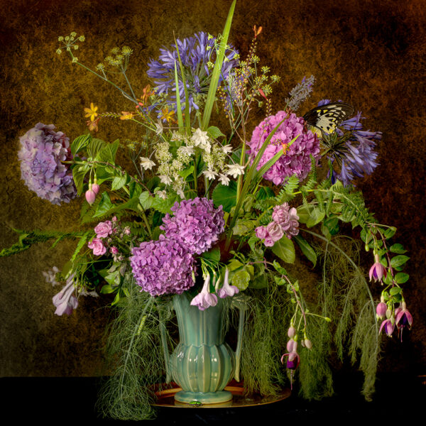 A vase filled with purple flowers on top of a table.