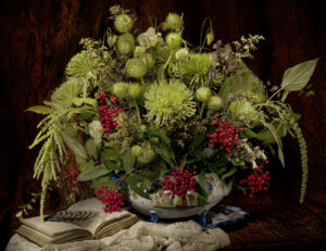 A bowl of flowers on top of a table.