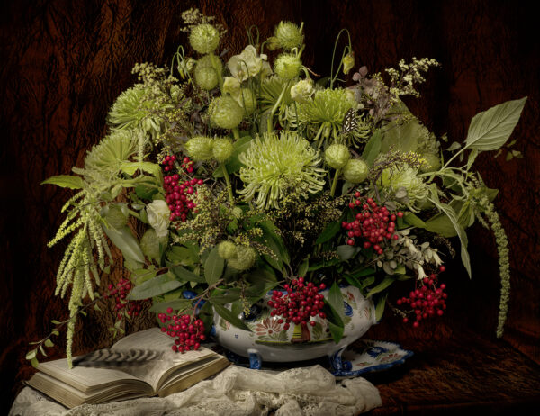 A bowl of flowers on top of a table.