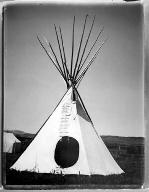A black and white photo of an indian teepee.