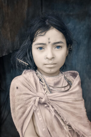 A young girl with blue eyes and black hair.
